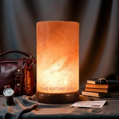 Modern handcrafted Himalayan pink salt cylinder shaped lamp H 17cm W 9.5cm glowing on neem base by The Nature Vibe