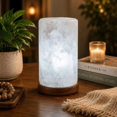 Handcrafted Himalayan white salt cylinder shaped lamp H 17cm W 9.5cm glowing on neem base by The Nature Vibe